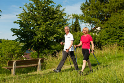 Person enjoying a peaceful outdoor walk as part of their daily movement practice